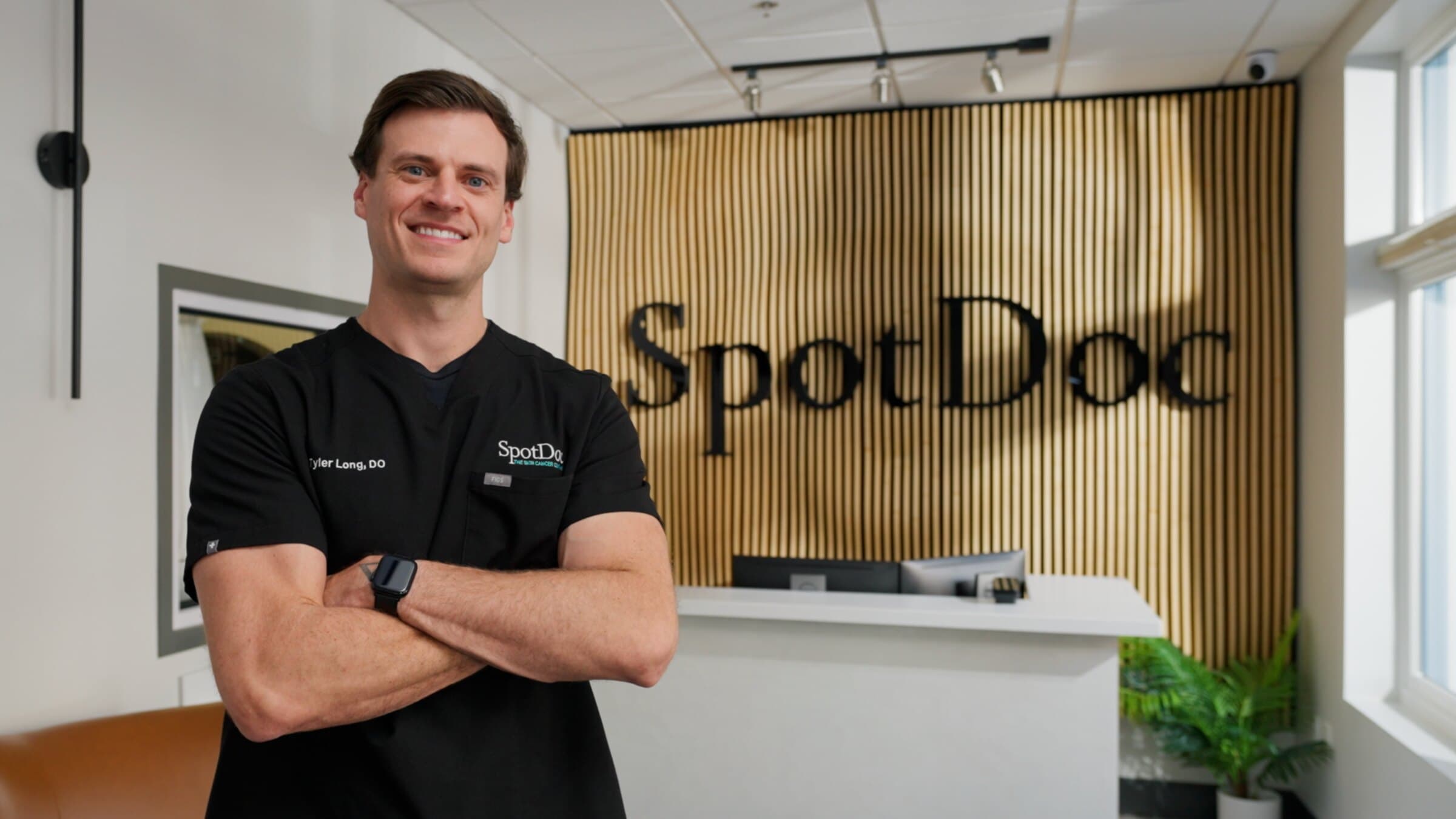 Tyler Long, DO, board-certified dermatologist, in the SpotDoc clinic lobby