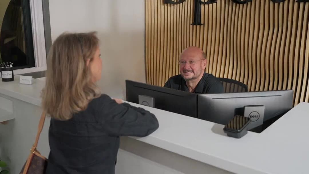 A patient being welcomed at the SpotDoc front desk in Brownwood Square